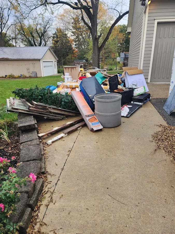 Dumpster being loaded with debris for 12 Yard Dumpster Rental in Gilbert